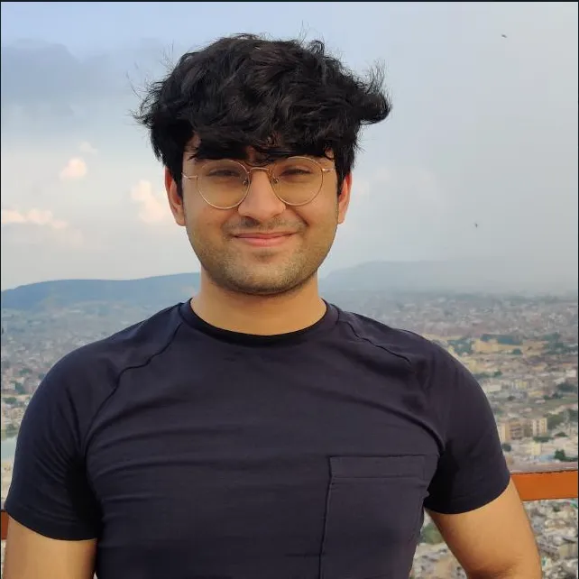 Portrait of Yash Khurana at dusk, city skyline behind
